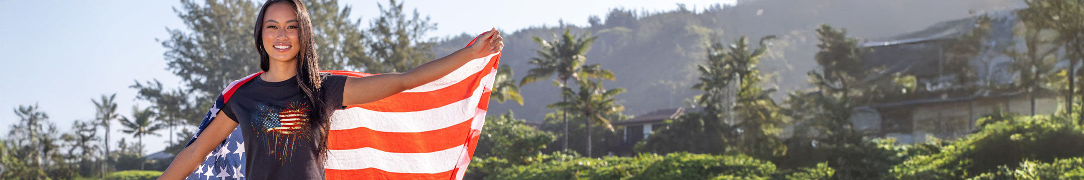 Woman holding an American flag with a scenic background