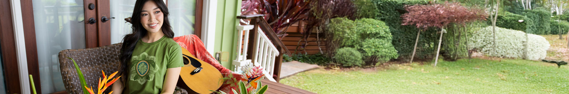 Woman sitting on a chair with a guitar in a garden setting