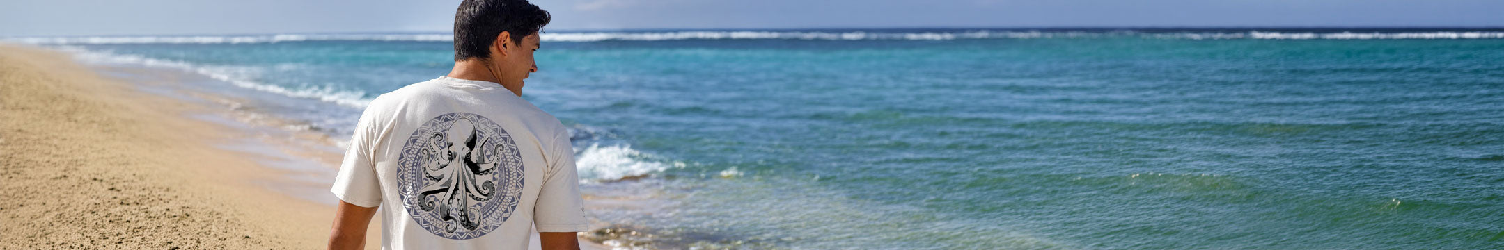 Person standing on a beach with ocean waves in the background