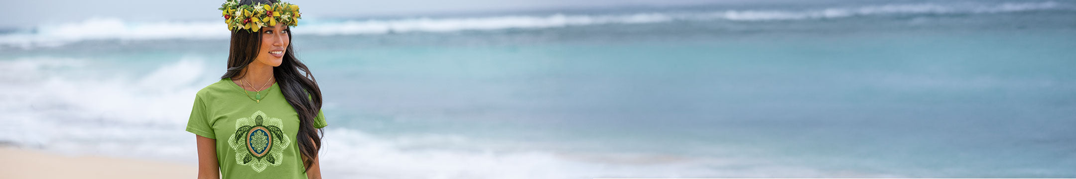 Woman wearing a green t-shirt with a turtle design on a beach