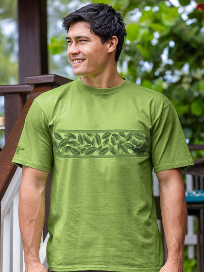 Man wearing a green t-shirt with leaf design outdoors