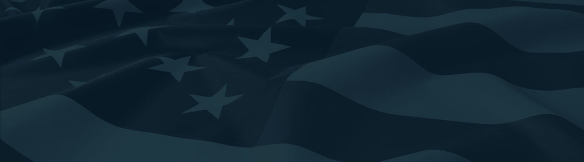 Dark navy blue flag with wavy fabric folds and several white stars, shown close up against a matching dark background.