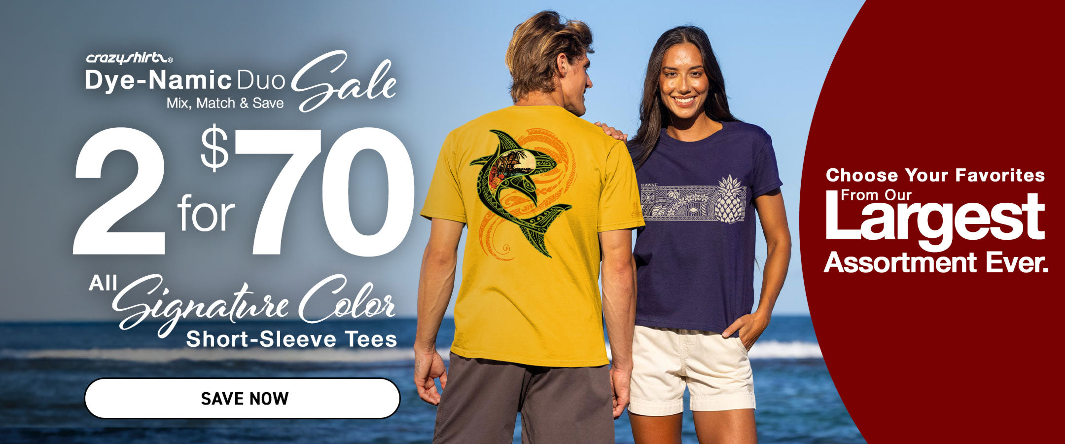 Two people standing on a beach with a promotional banner for a clothing sale.