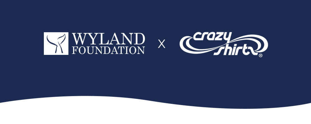 Collaboration logo between Wyland and Crazy Shirts on a blue and white background