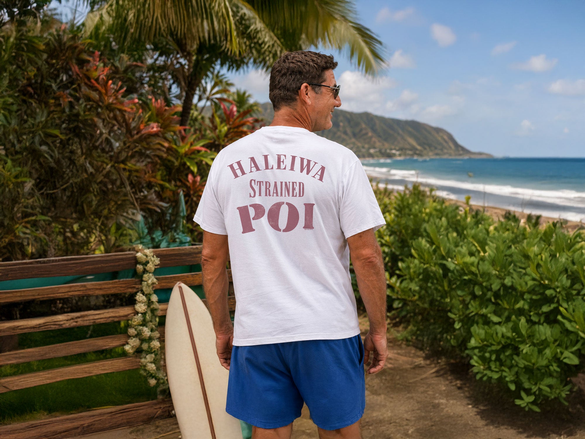 Person wearing a white t-shirt with red text on the back, standing outdoors.