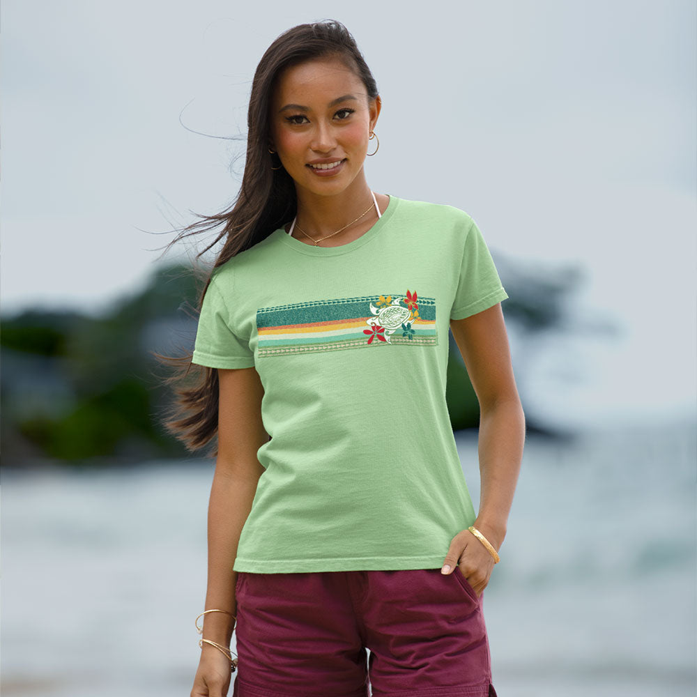 Woman in a green shirt standing at the beach