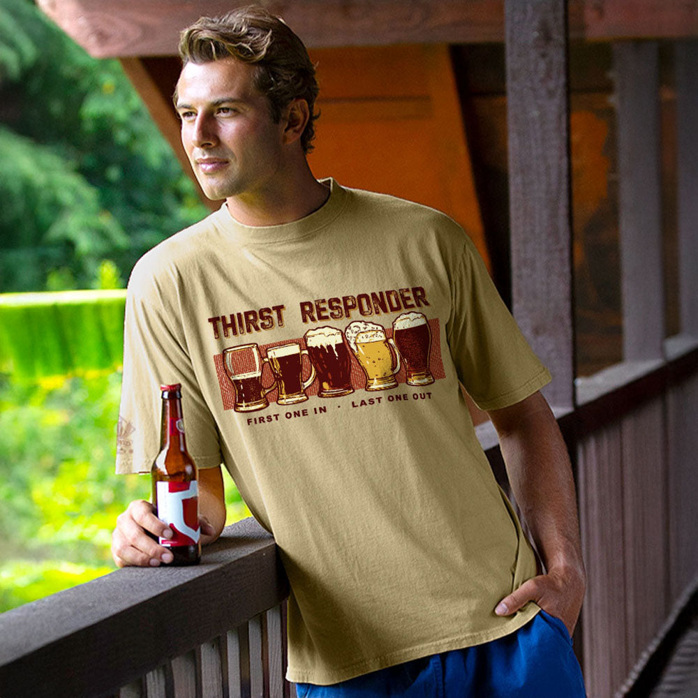 Man wearing a 'Thirst Responder' t-shirt holding a beer bottle on a wooden deck.
